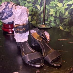 Michael Kors black heels. Has a buckle strap around the ankle. Very pretty GUC